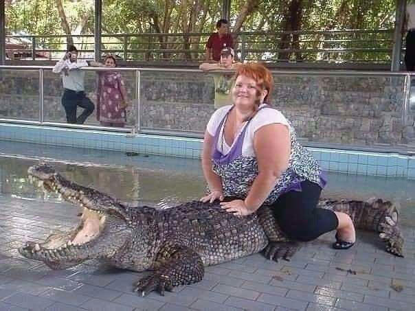 oh my god that poor creature, fat lady riding crocodile