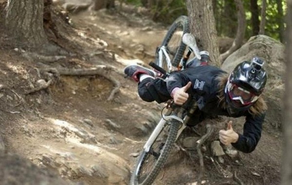 thumbs up on the way down, mountain bike wipe out caught at the perfect moment, timing