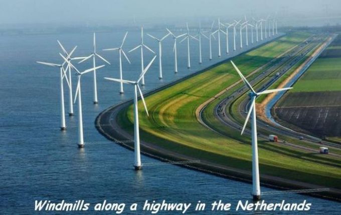 windmills along a highway in the netherlands