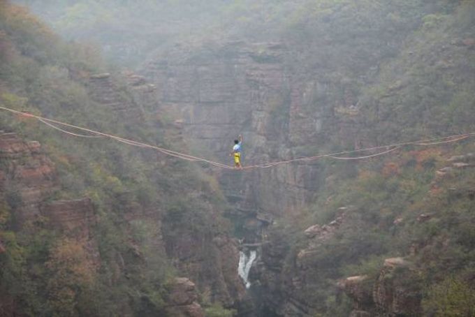 walking a tight rope over a canyon