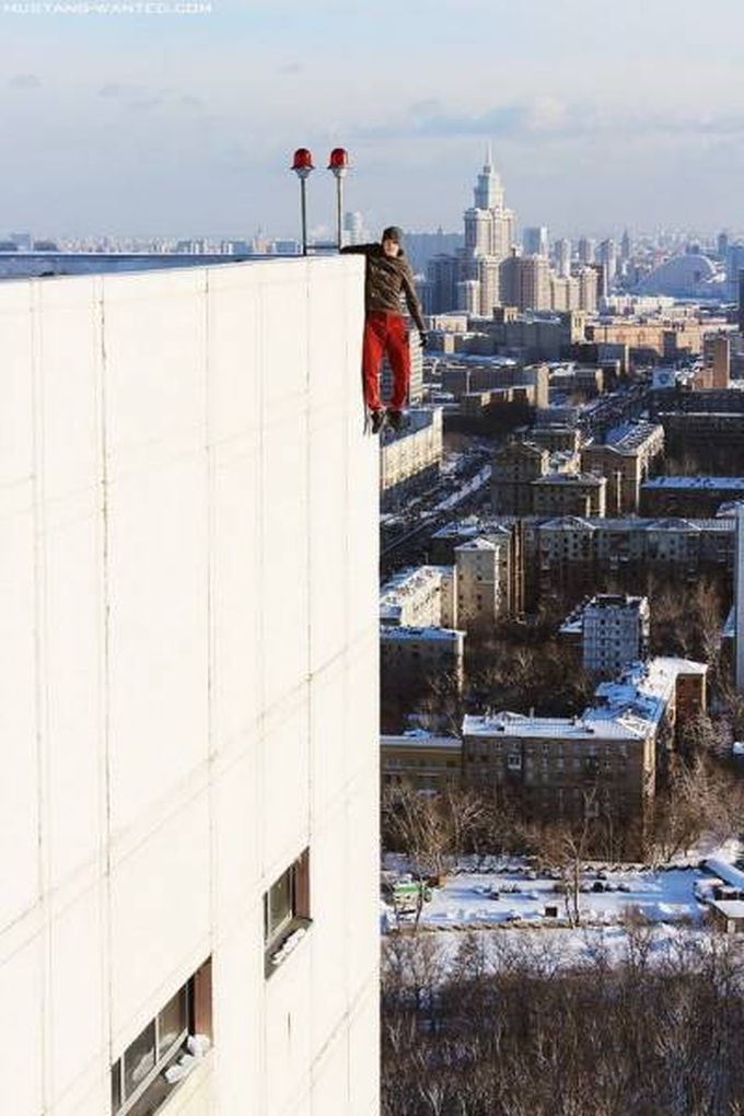 guy hanging off the side of a building
