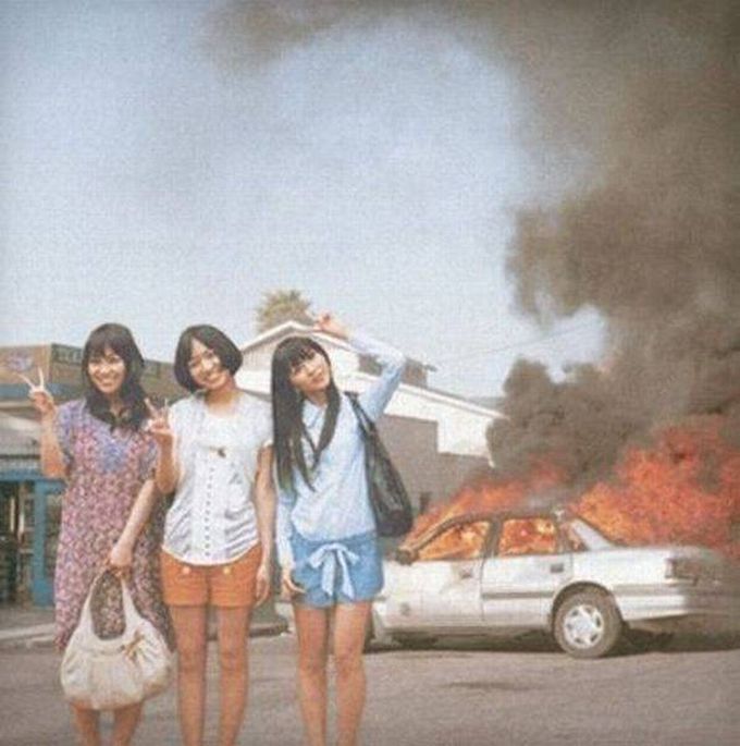 chinese people will pose for photographs in front of anything, car on fire