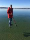 jesus's descendant walks on water, thin clear ice over lake makes it look like this guy is floating on the water