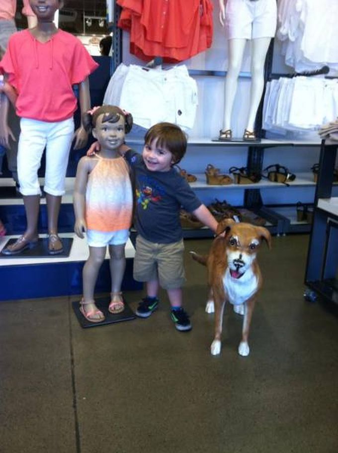kid finds his dream life at old navy, kid with mannequin girl and dog