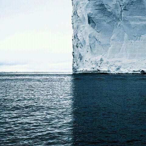 a photo with four perfect quadrants, ice berg, ocean
