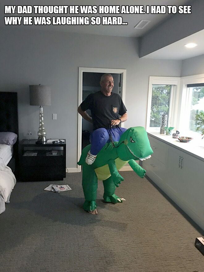 my dad thought he was home alone, i had to see why he was laughing so hard, man riding dinosaur costume