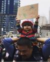 the right way to protest, kid holds up scribble sign at protest