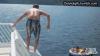 guy standing on slide slips, hits bottom of slide and bounces onto an inflatable raft, fail, lol