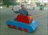 man in army uniform sitting in playground toy tank, lol