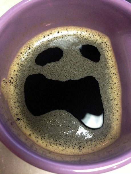 scared ghoulish face in coffee bubbles