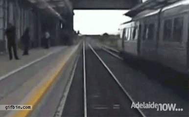 guys runs across tracks to get on landing and just barely escapes getting crushed by the train, close call