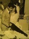 groom cutting wedding cake with a big saw, wtf
