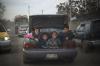 four kids riding in a car trunk