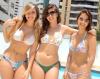 three cute girls pose in their swimsuits