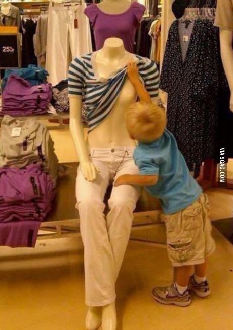 kid lifting mannequin shirt to see boobs, curious