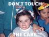 don't touch the cake, kid with angry look on her face