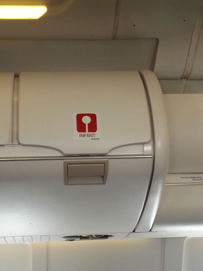 airplane, above head storage bins, infant storage compartment
