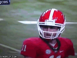 football player has the look of fear right before being tackled