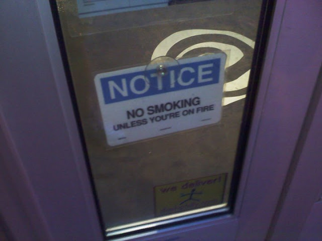 notice, no smoking, unless you are on fire, lol, sign