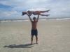 guy lifts girl on beach and makes a centaur shadow