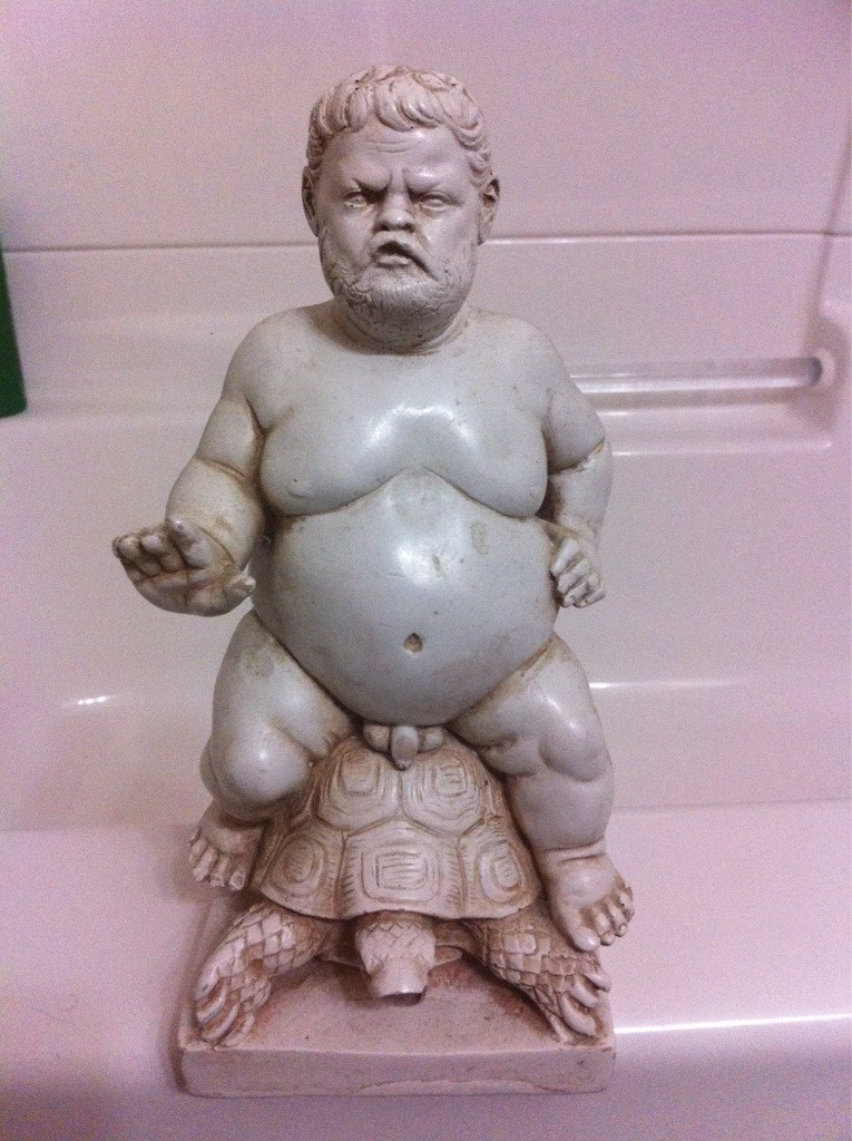 statue, old naked fat man riding a turtle