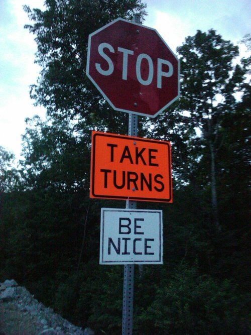 stop, take turns, be nice, street sign