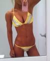 girl in yellow bikini takes selfie
