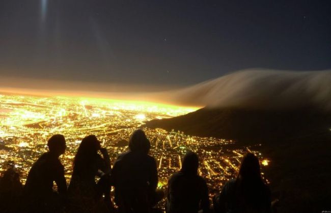 city lights at night, clouds rolling in