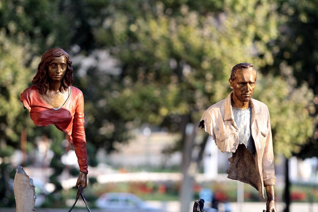 sculptor bruno catalano's life-size bronze "travelers" amazingly seem to be disappearing