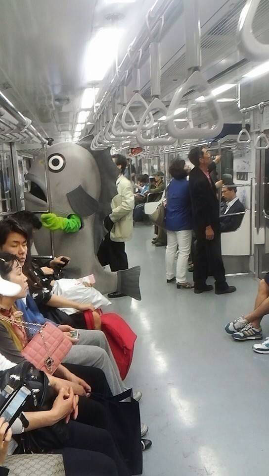 giant fish costume in subway, public transportation