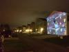 playing mario kart on the side of a house, projector, nintendo, win