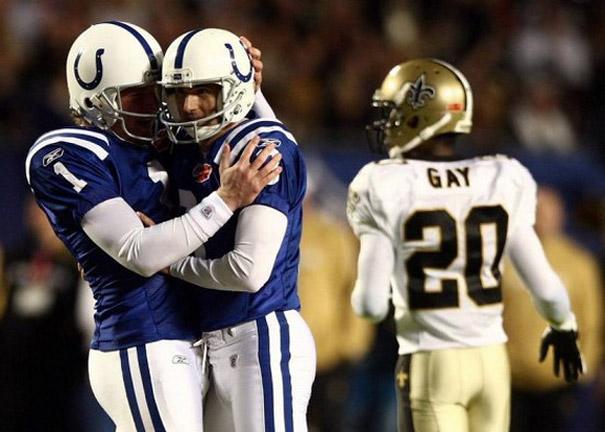 two football players hug as gay walks by, timing