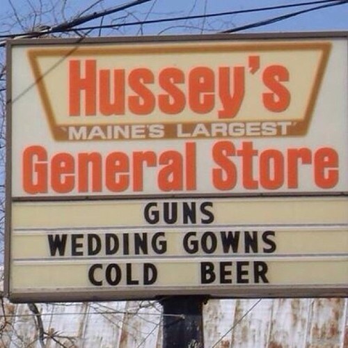 all three of life's essentials, wedding gowns, cold beer, guns, sign