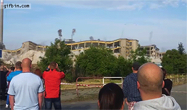 guy looking at demolition almost hit by flying rock