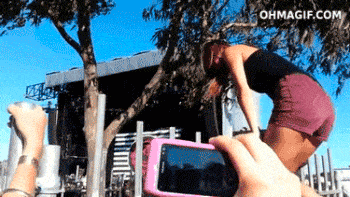 girl wedgies herself on a fence in front of tons of people, fail