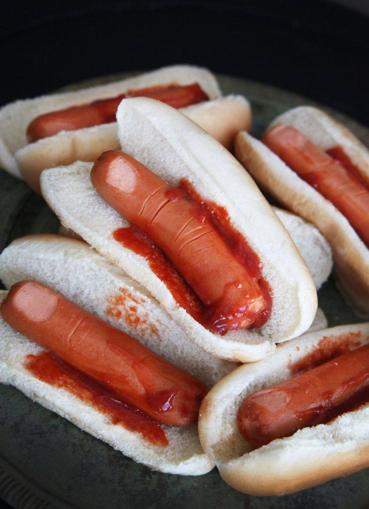 halloween hot dogs, fingers on a bun