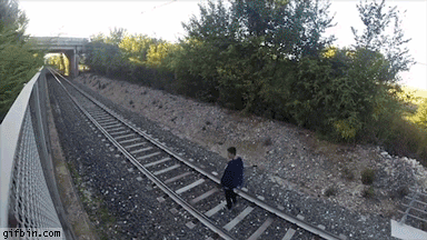 kid lays down under a moving train, do not try this at home