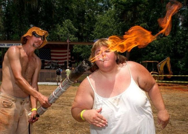 redneck picture of the day, fat girl lighting cigarette from torch