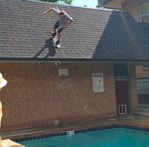 skateboarding off the roof into a pool