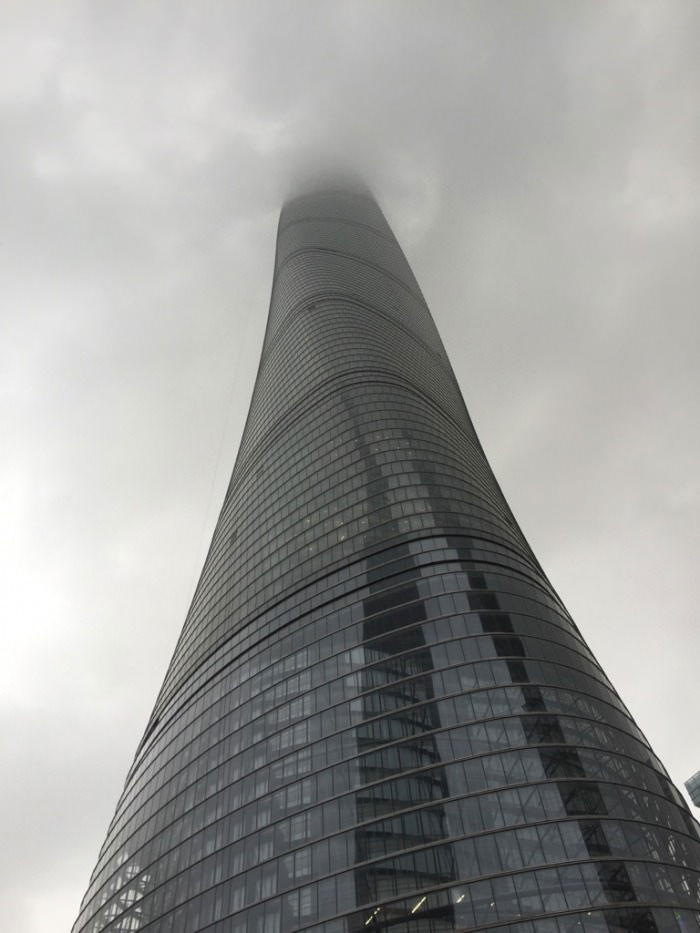 building in shanghai goes up beyond the clouds, amazing man made structures