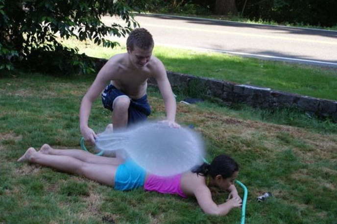 subzero origins, perfectly timed photo of a big water balloon breaking over a girl