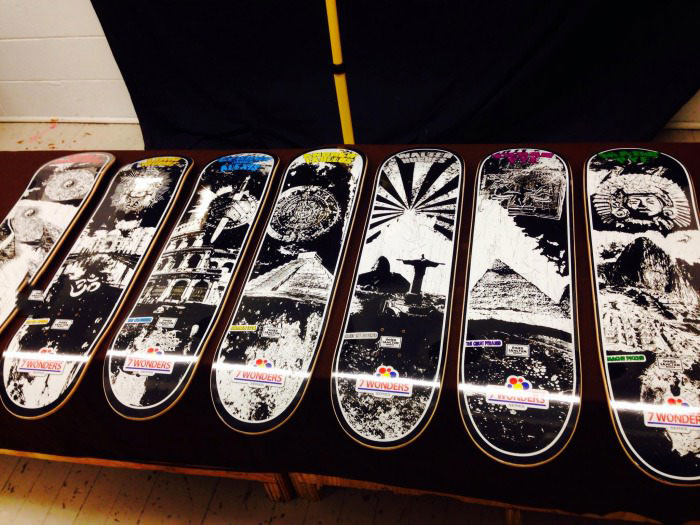 just a few skateboards with artwork of the seven wonders of the world