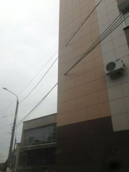 electricity wires going straight through building corner, wtf, engineering fail