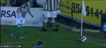 soccer player kicks the wrong object during corner kick