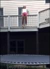 girl jumps onto trampoline from second floor deck and crumbles, fail