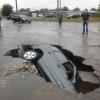 when parking your car goes horribly wrong, sink hole in the road