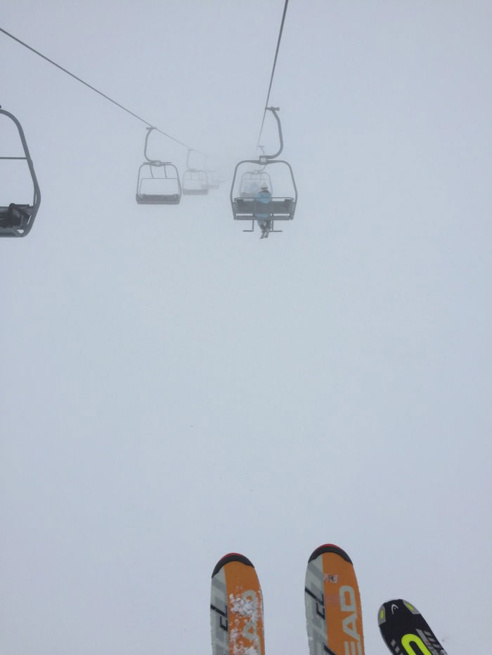 rising to the heavens on a ski lift, fog