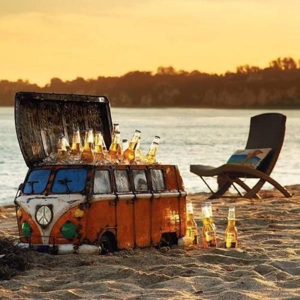 beer on ice in a bus painted cooler on a beach