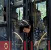 getting on the bus is a real challenge for some people, girl with head stuck in bus doors