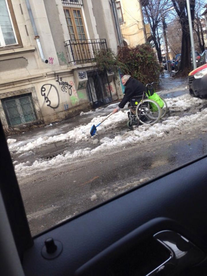 man in wheelchair shovelling snow, what is your excuse?